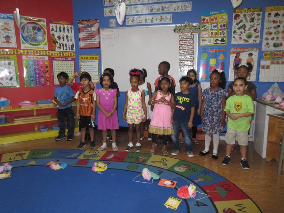 Group of children standing in a classroom