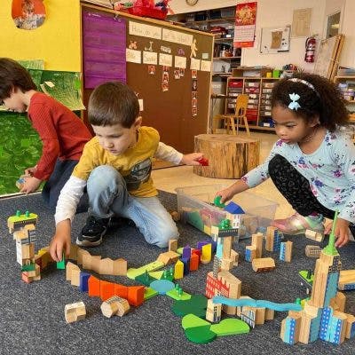 Children playing with building blocks in a classroom