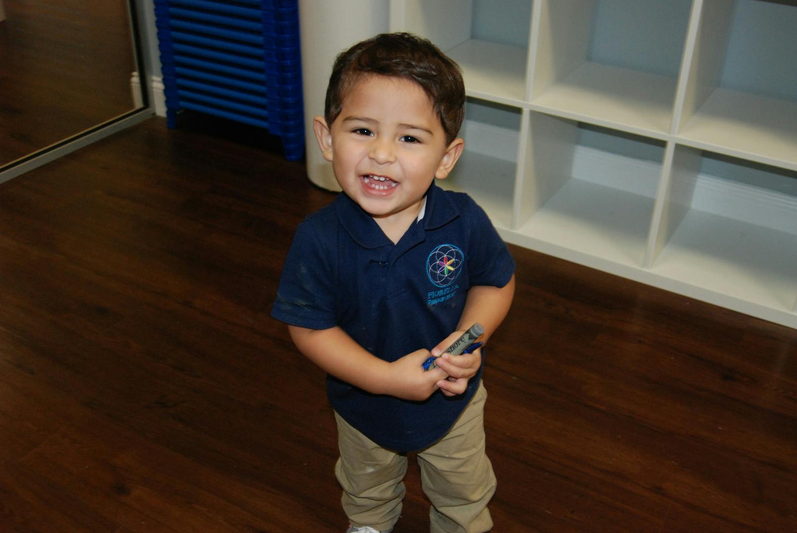 Child standing and holding an object
