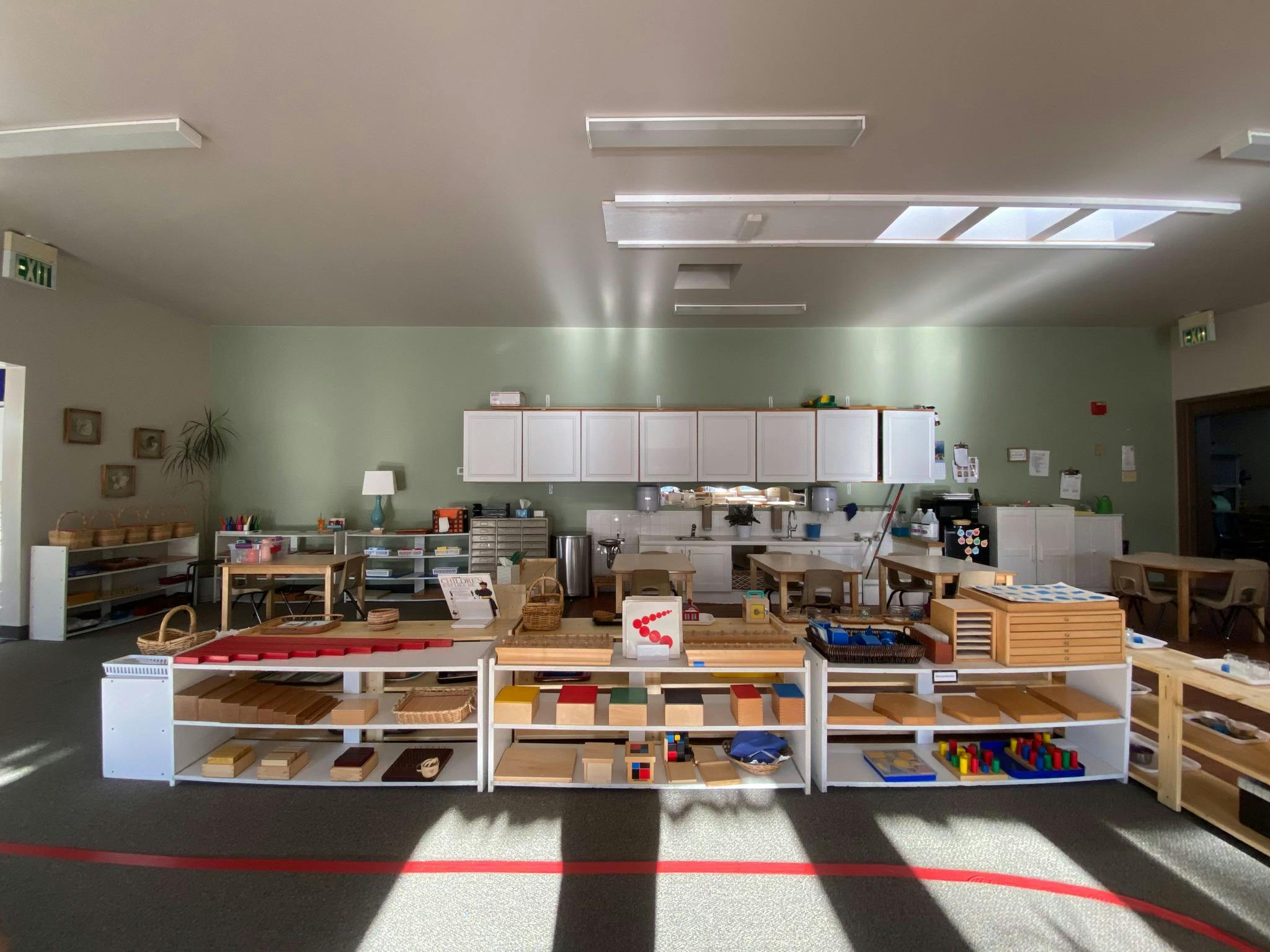 Classroom with shelves of learning materials and tables