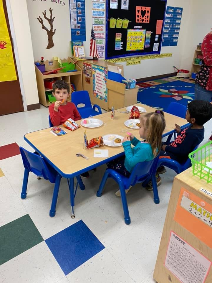 Children sitting at a table in a classroom