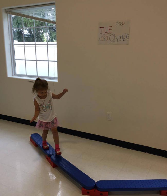 Child walking on a balance beam