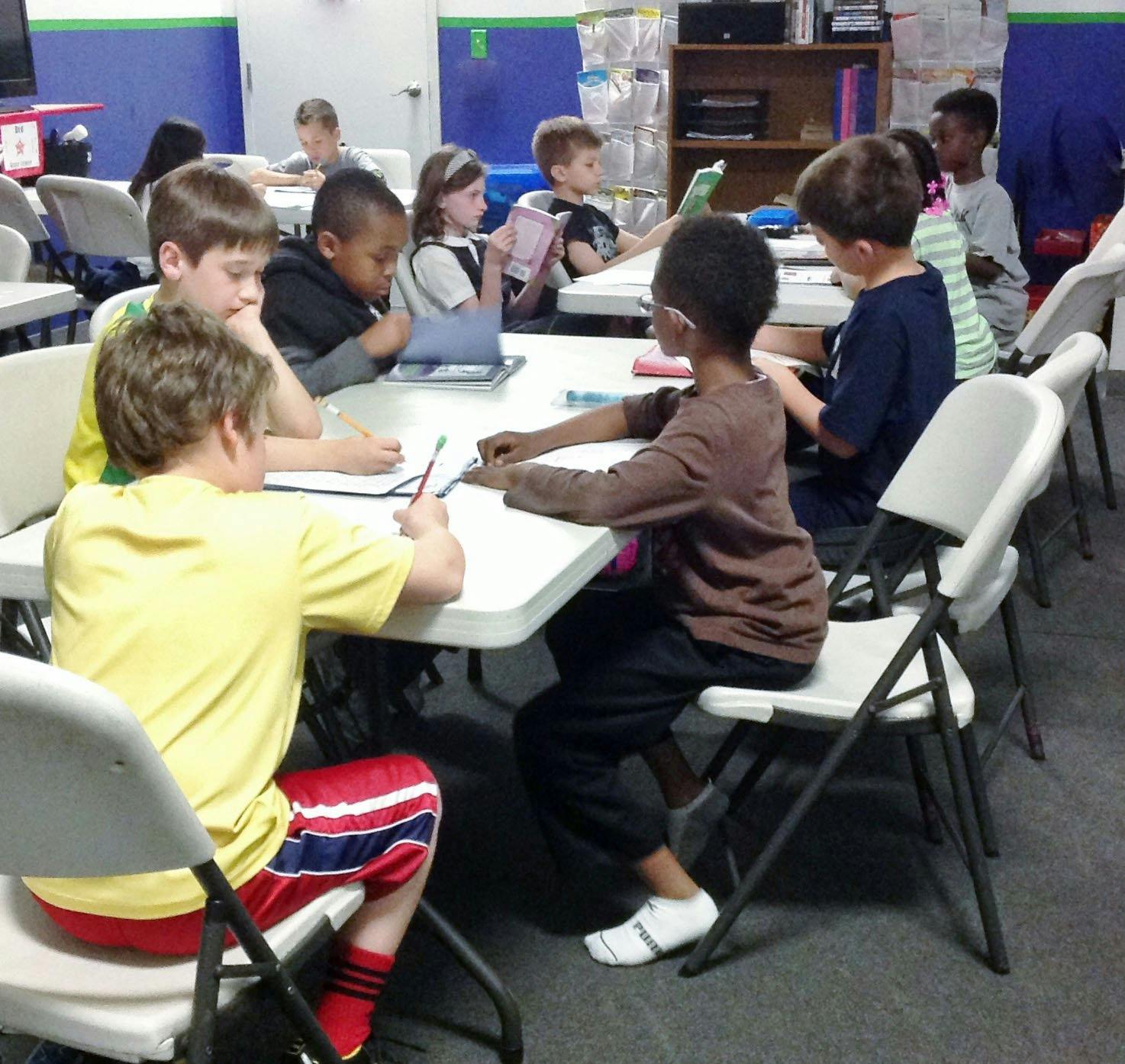 Children sitting at tables in a classroom