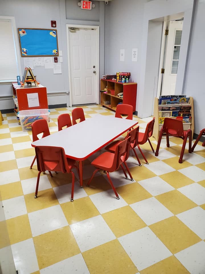 Classroom with small table and red chairs