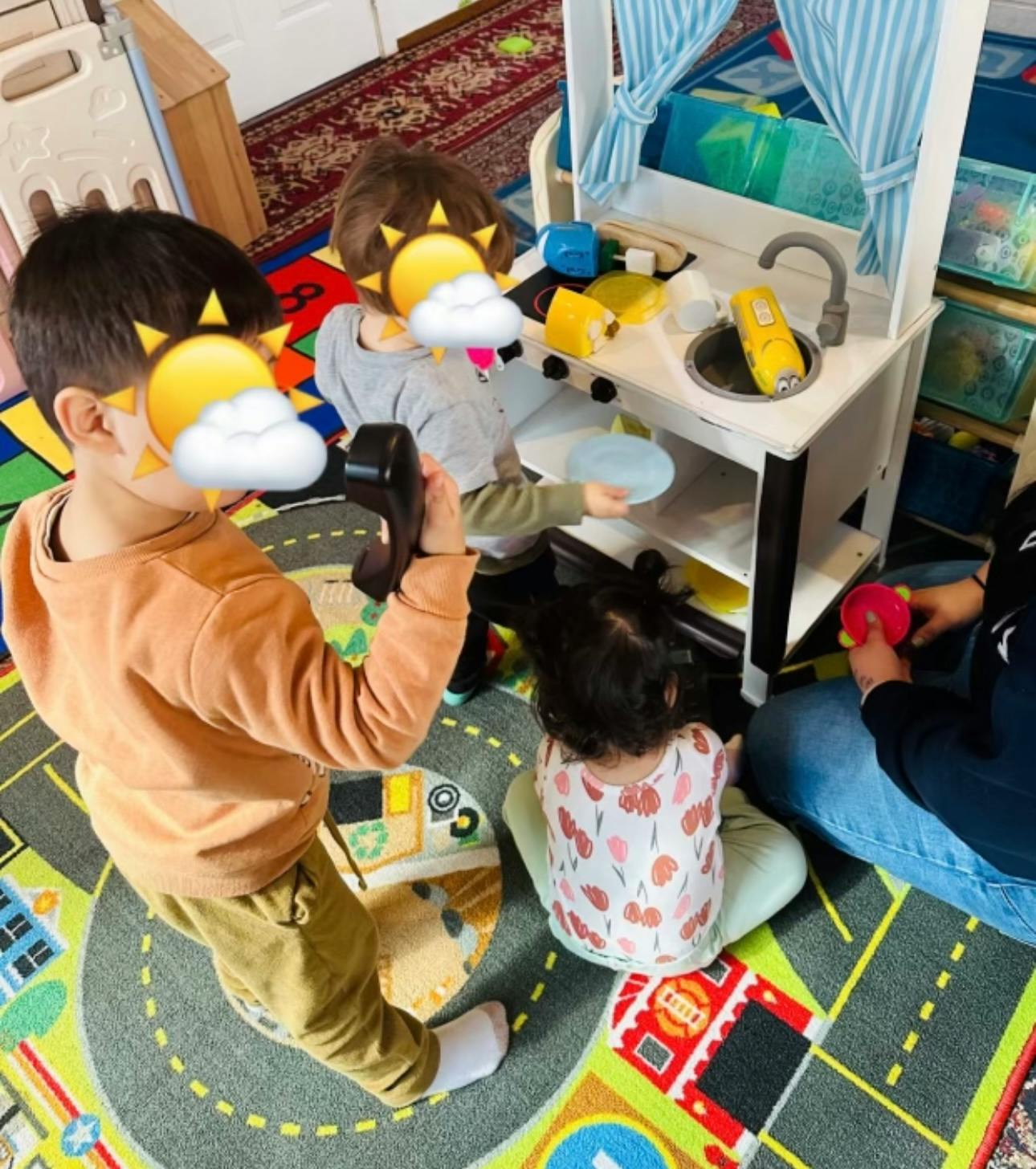 Children playing with a toy kitchen set