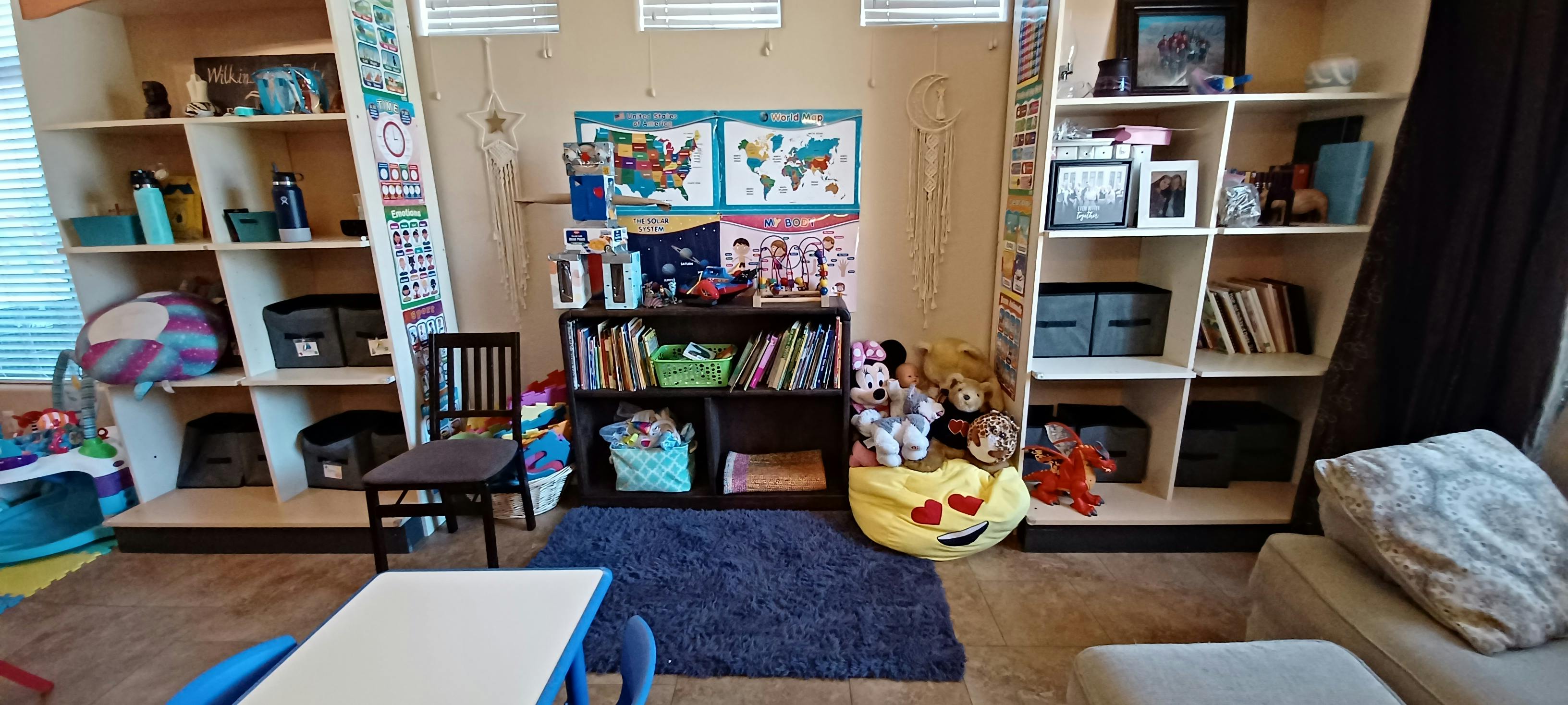 Room with bookshelves, a small table, and a rug