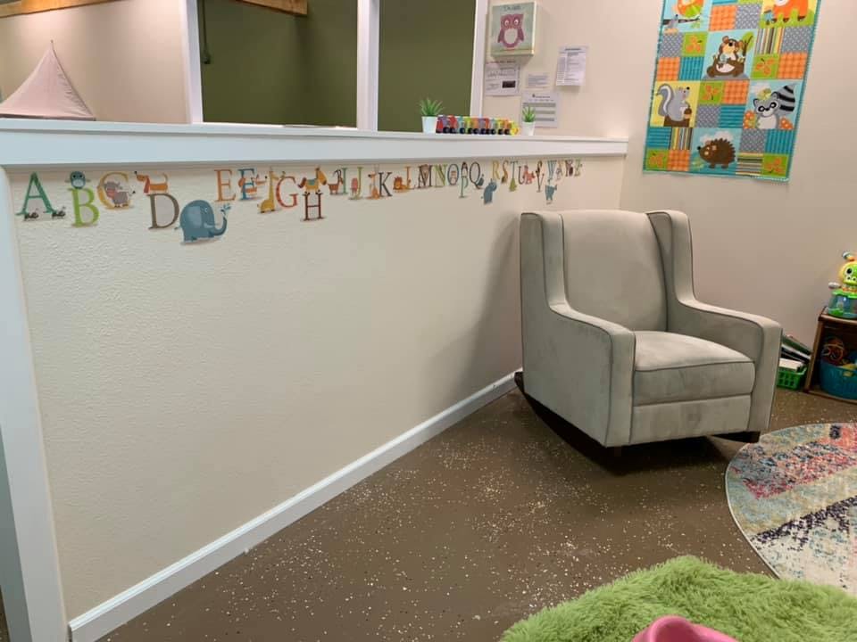 Rocking chair in a room with alphabet wall decals