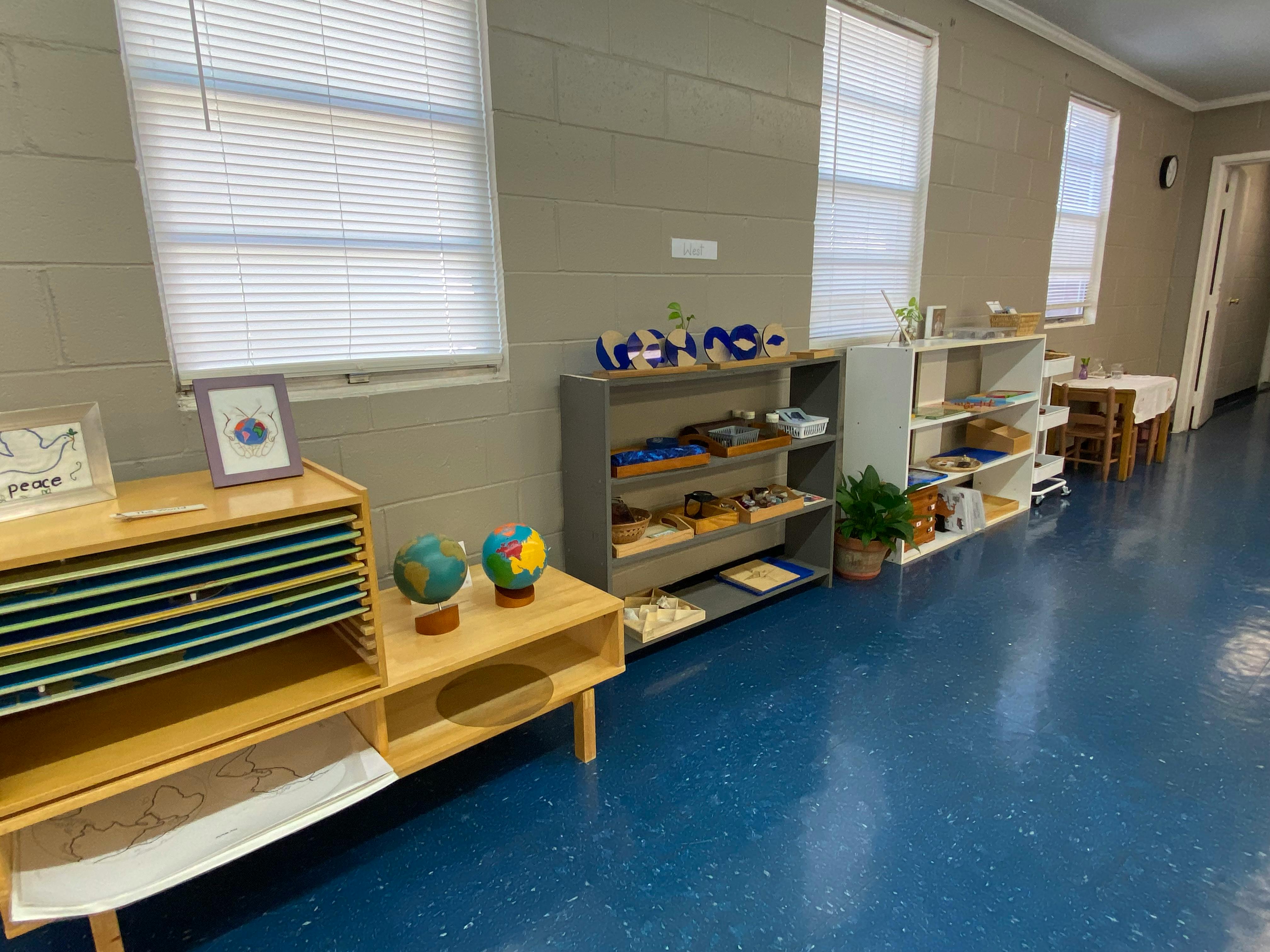 Classroom with shelves of learning materials and globes
