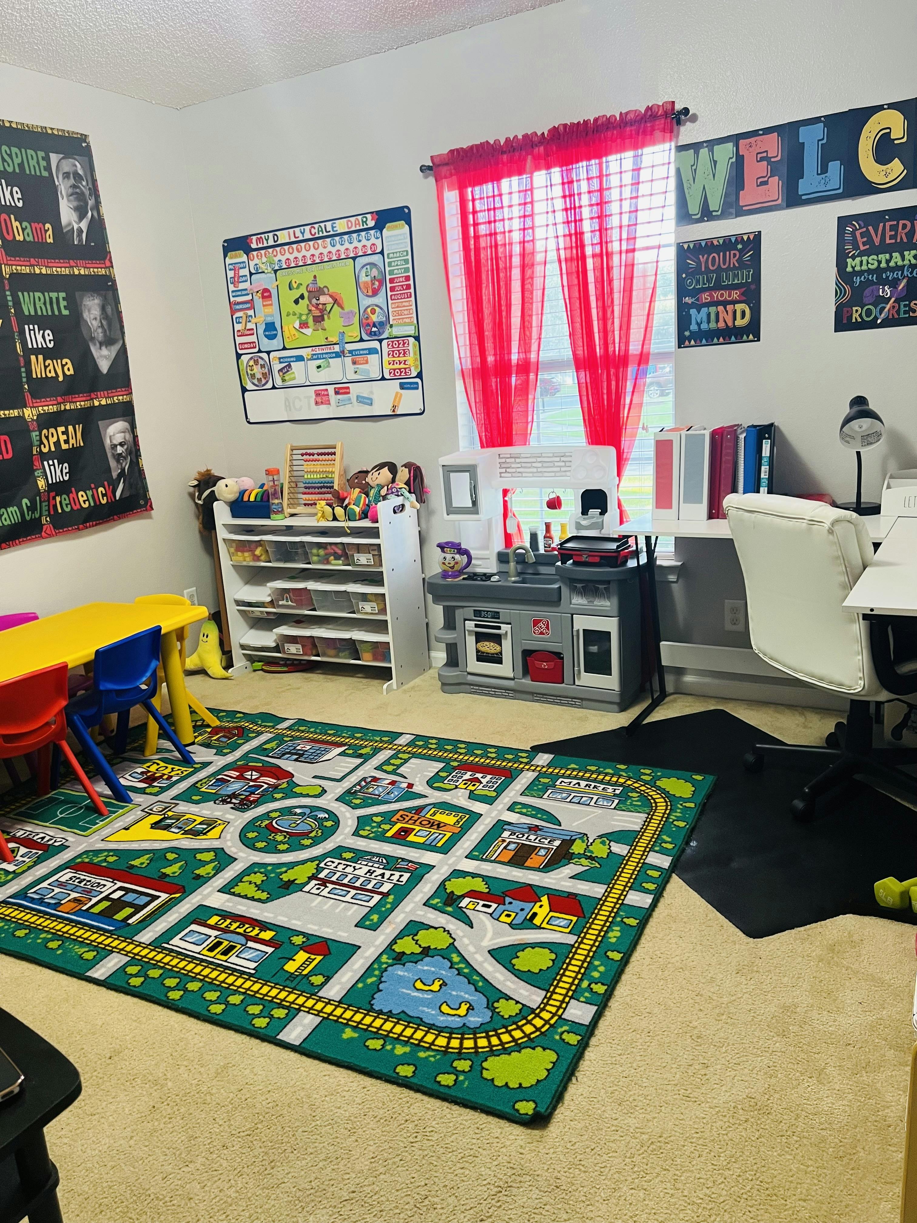Playroom with a road map rug, toy kitchen, and small table with chairs