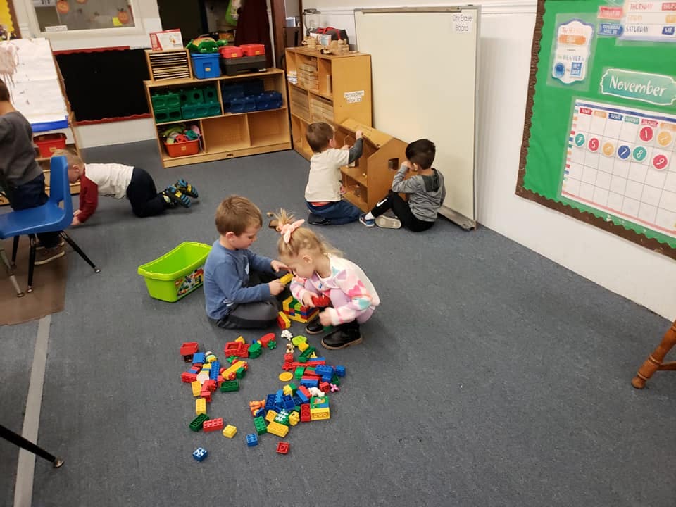 Children playing with building blocks in a classroom
