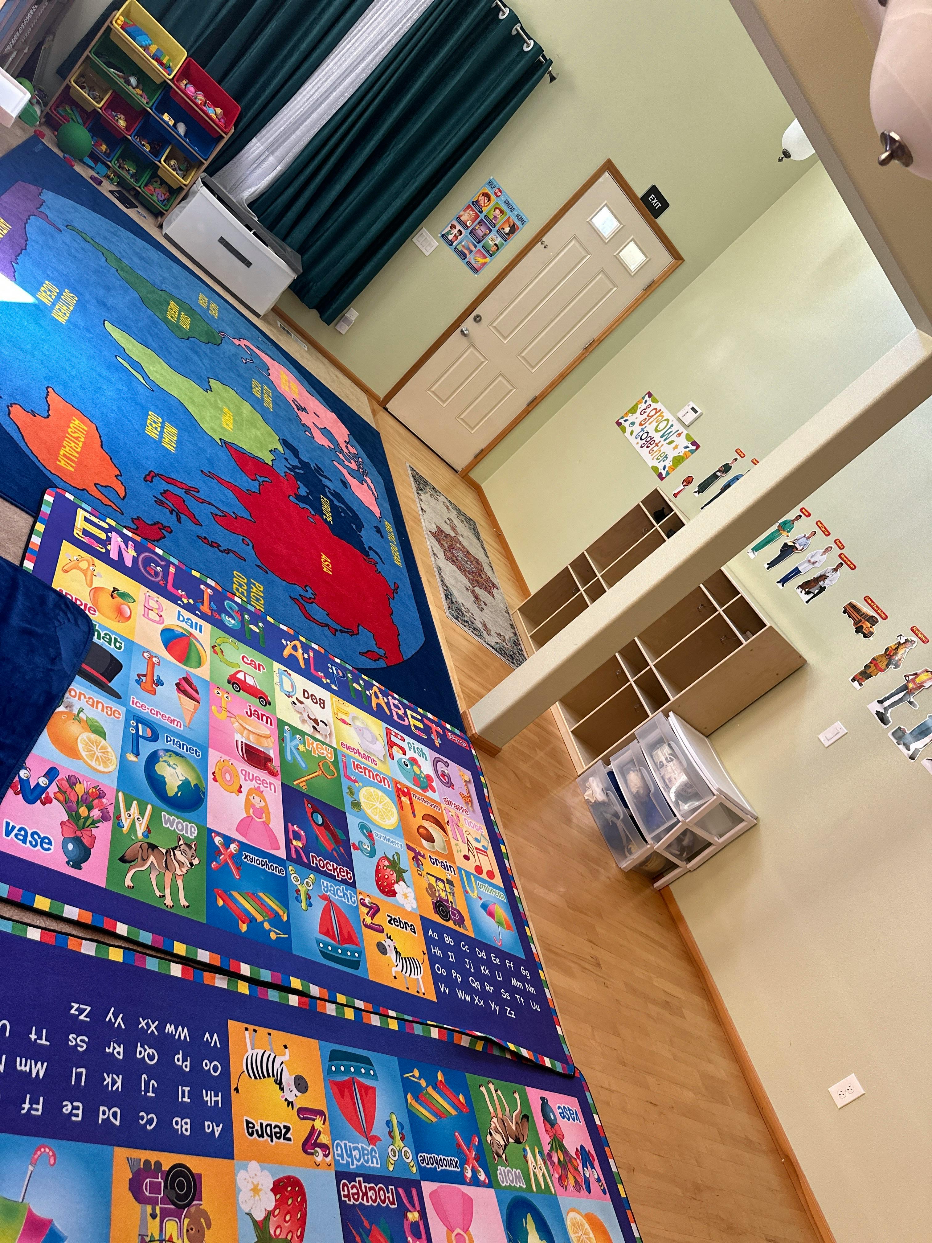 Classroom with alphabet and world map rugs