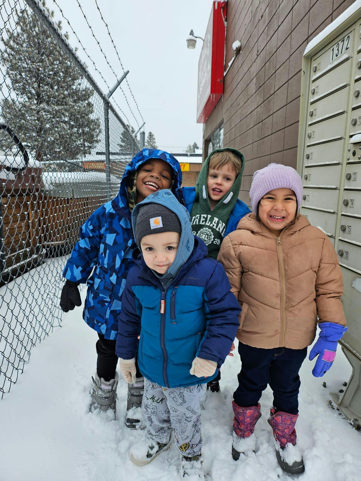 Four children standing in snow