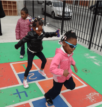 Children playing hopscotch outdoors