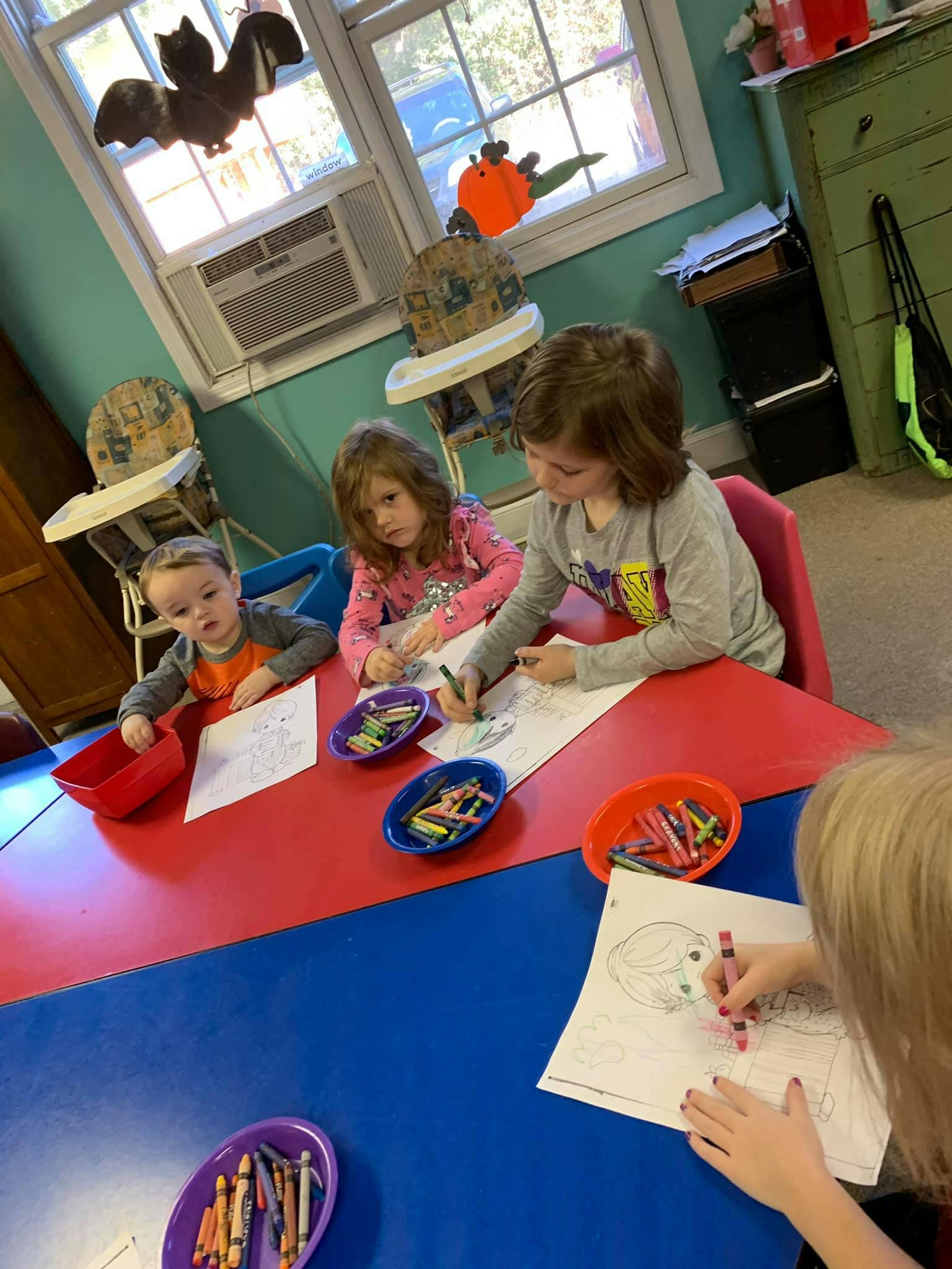 Children coloring at a table