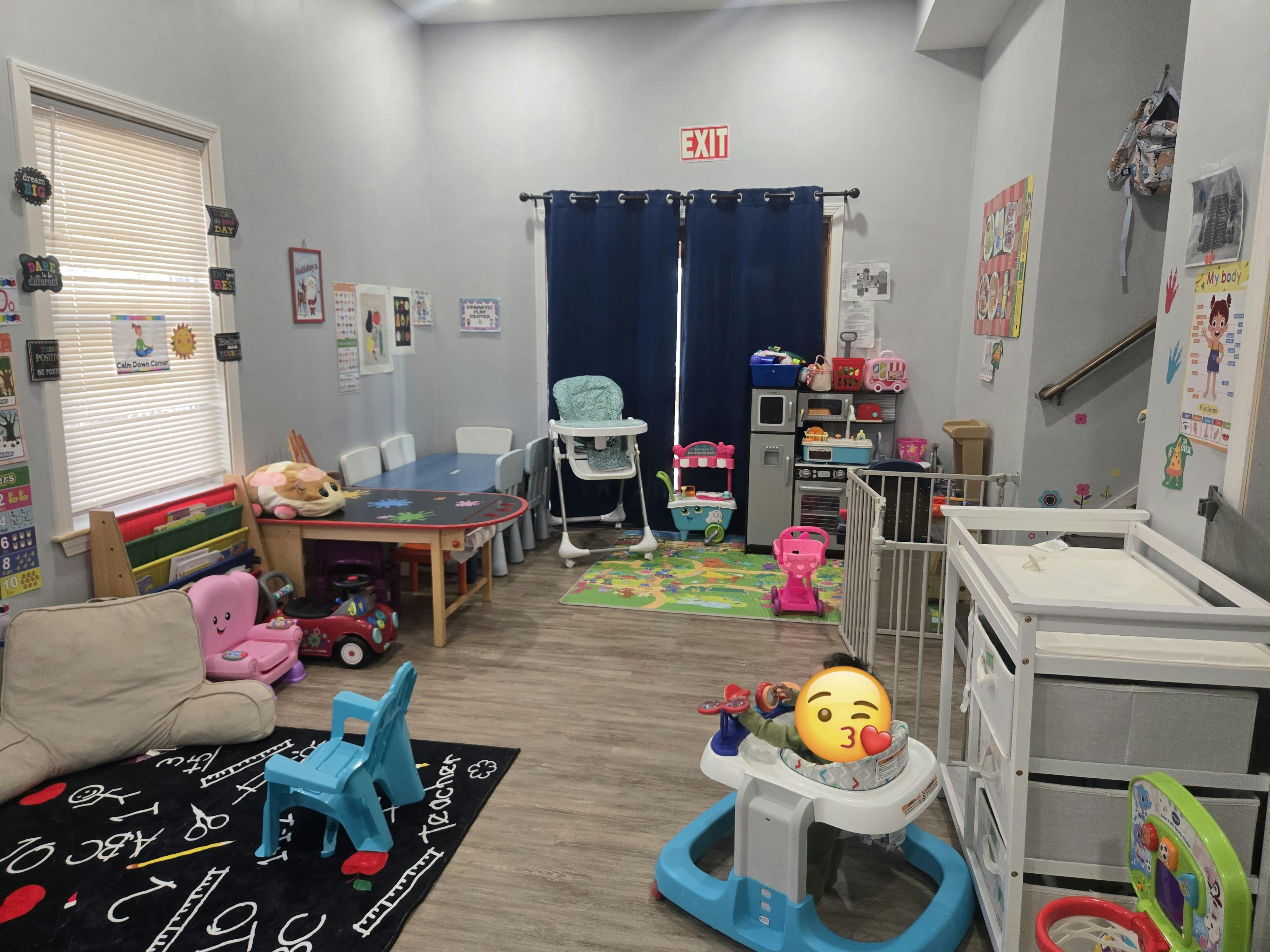 Playroom with small tables, chairs, and baby equipment