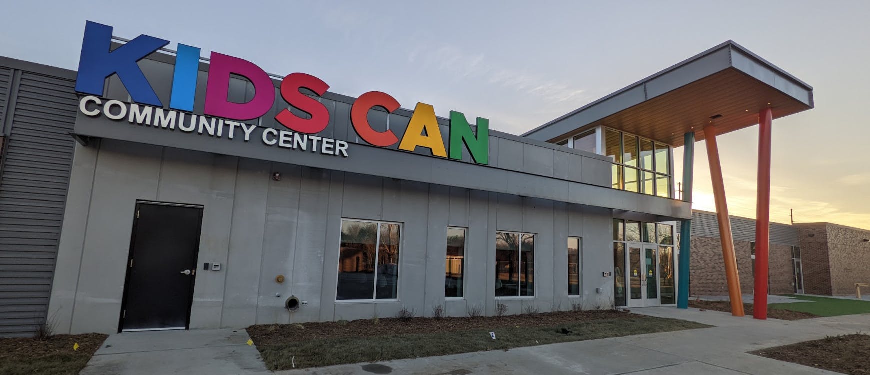 Kids Can Community Center building exterior with colorful sign