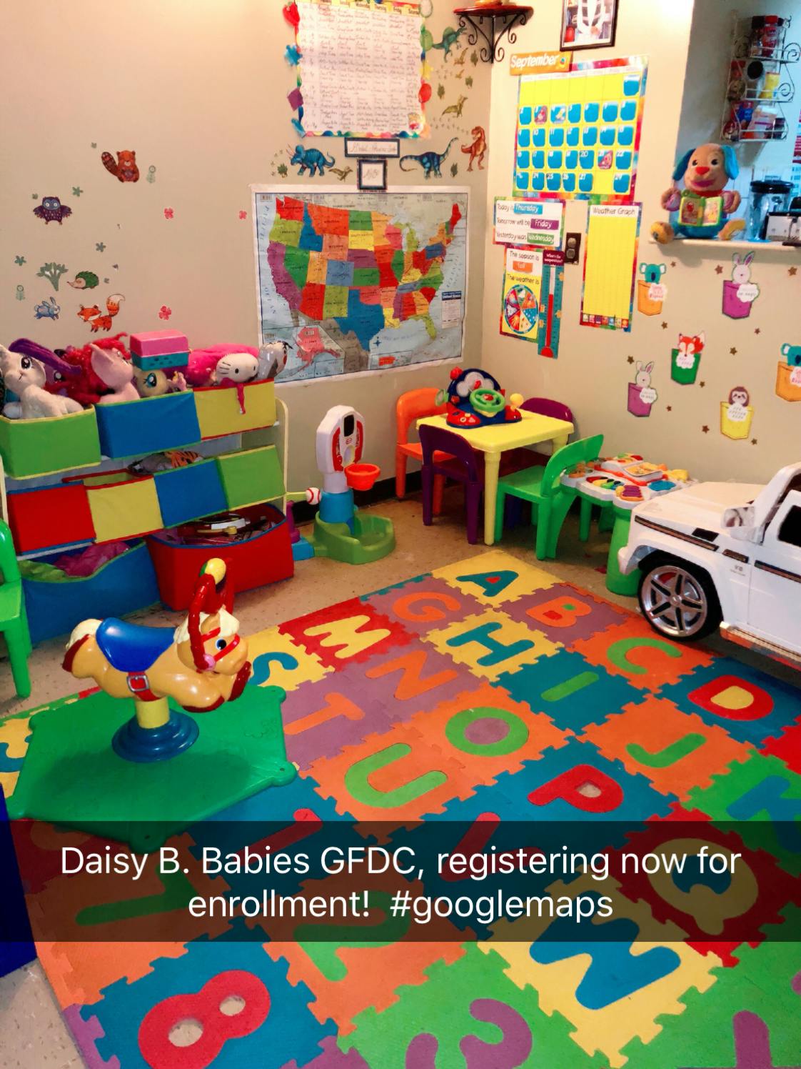 Playroom with colorful alphabet floor mats, toys, and small tables