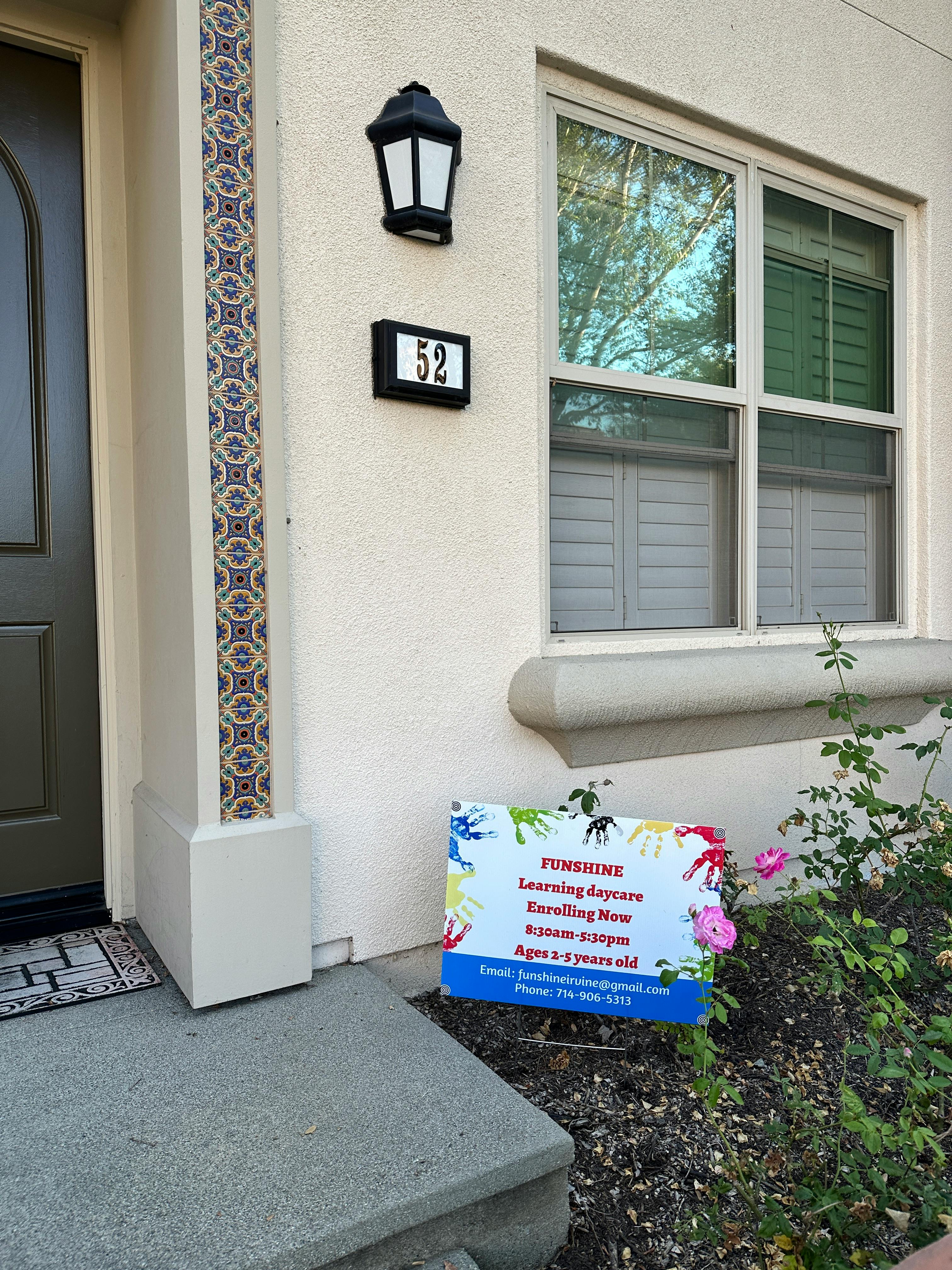 House exterior with a sign that reads "Sunshine Learning Daycare"