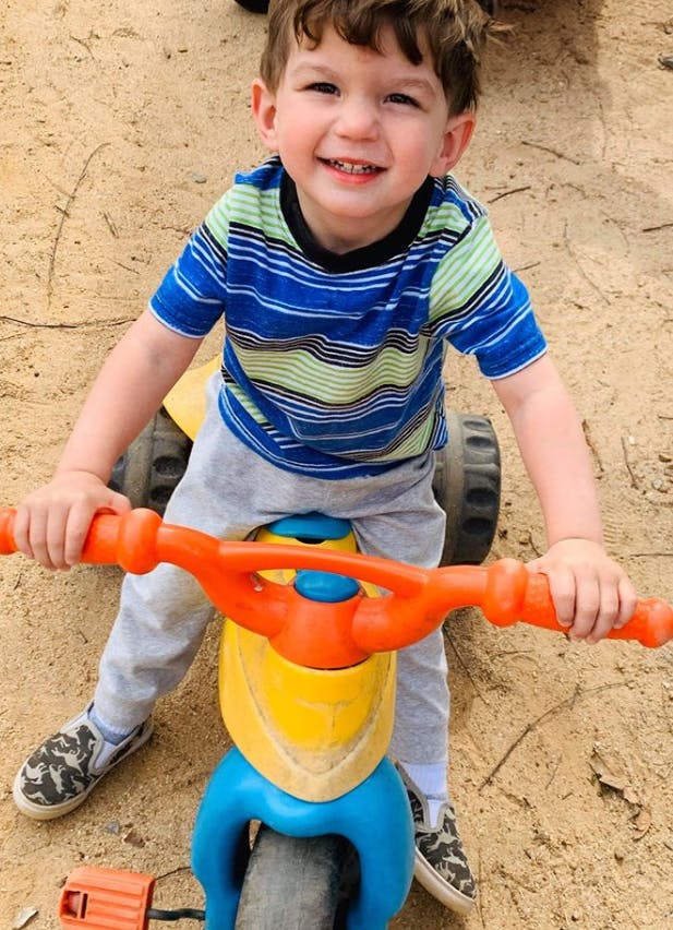 Child on a toy tricycle