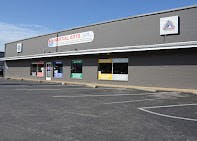 Exterior of a commercial building with a parking lot in front