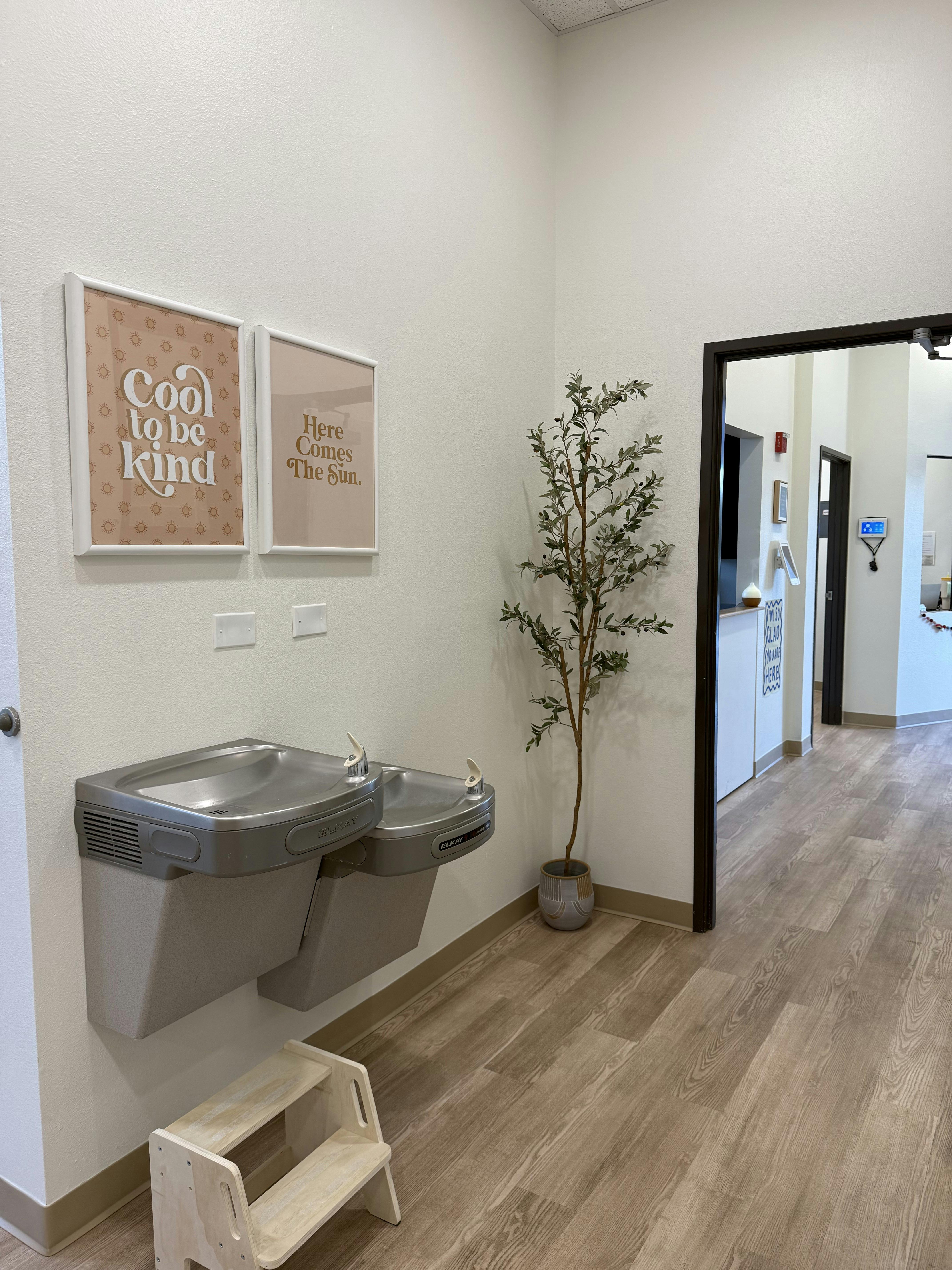 Water fountain with a step stool in a hallway