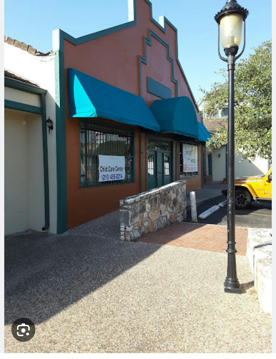 Building with blue awnings and a sign that reads "Child Care Center"