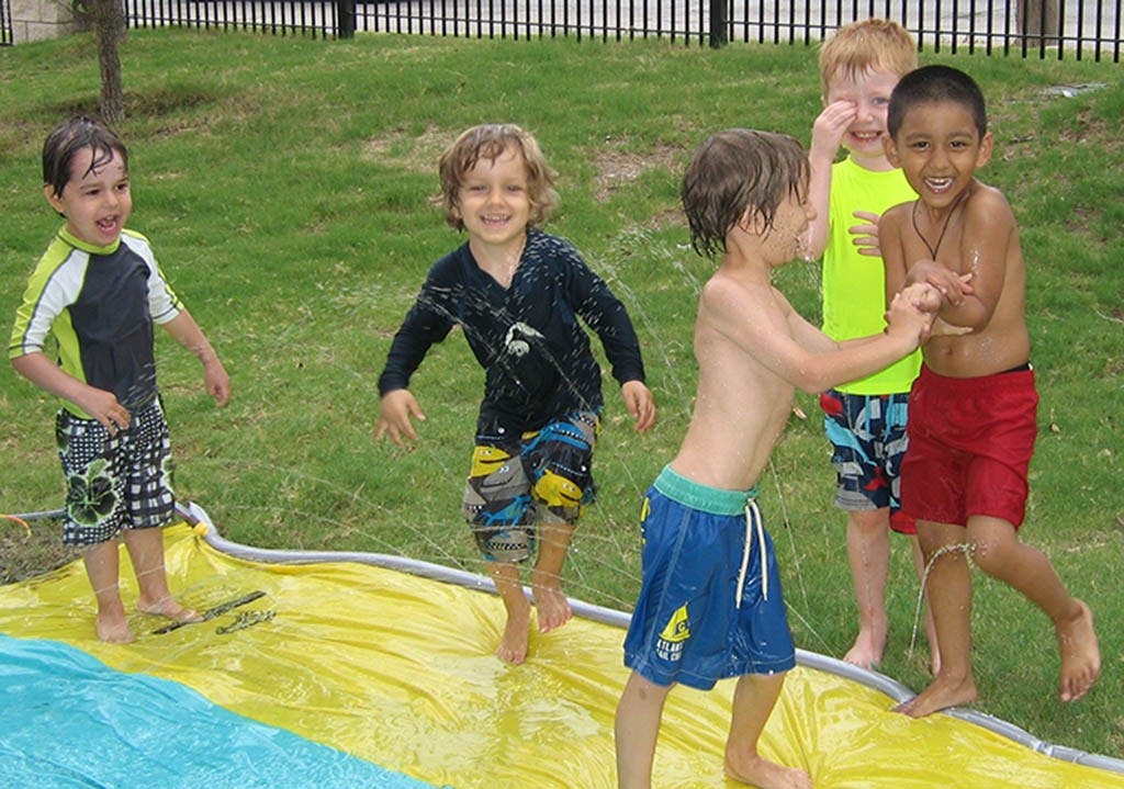 Children playing on a water slide