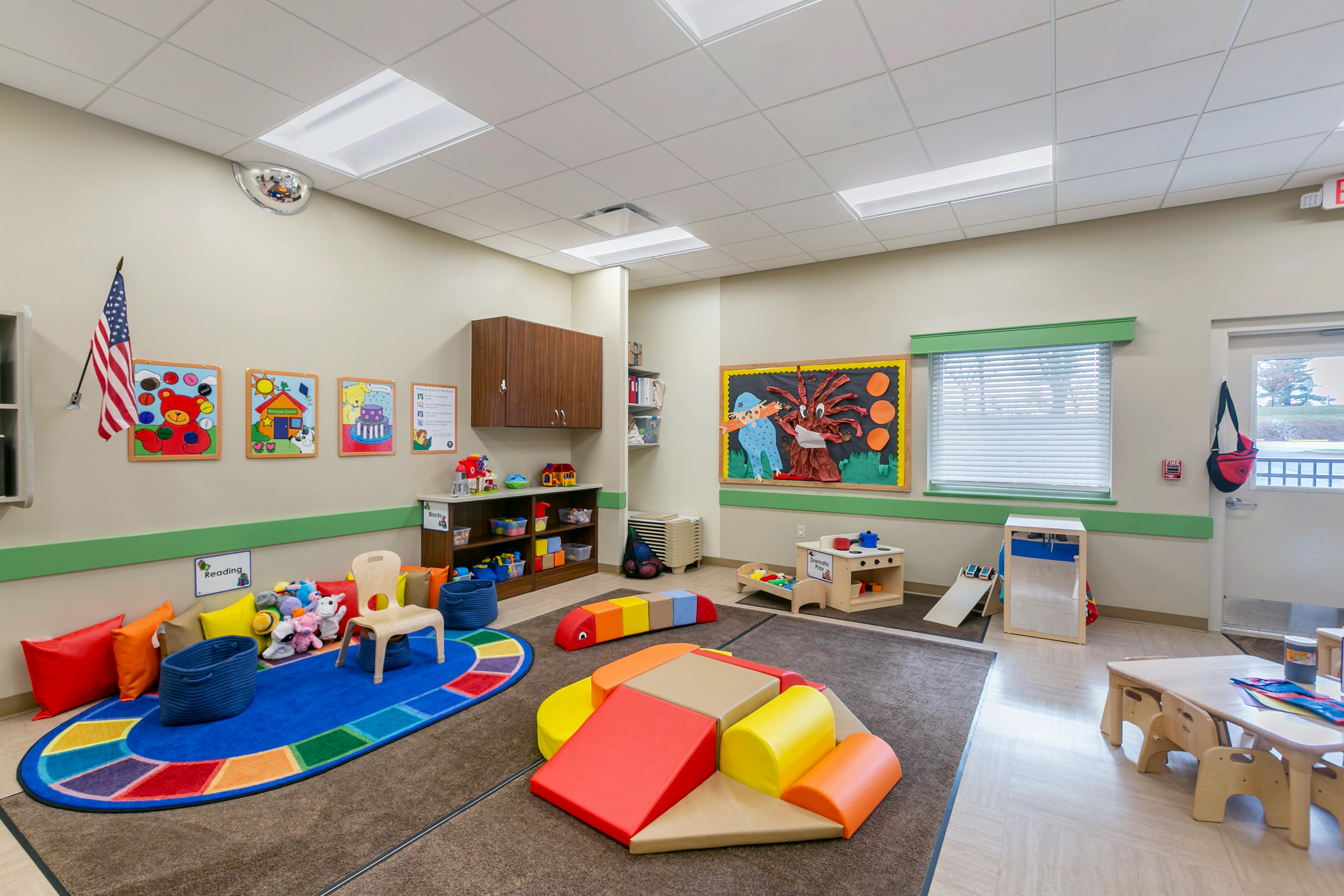 An empty early learning classroom with colorful toys and furniture