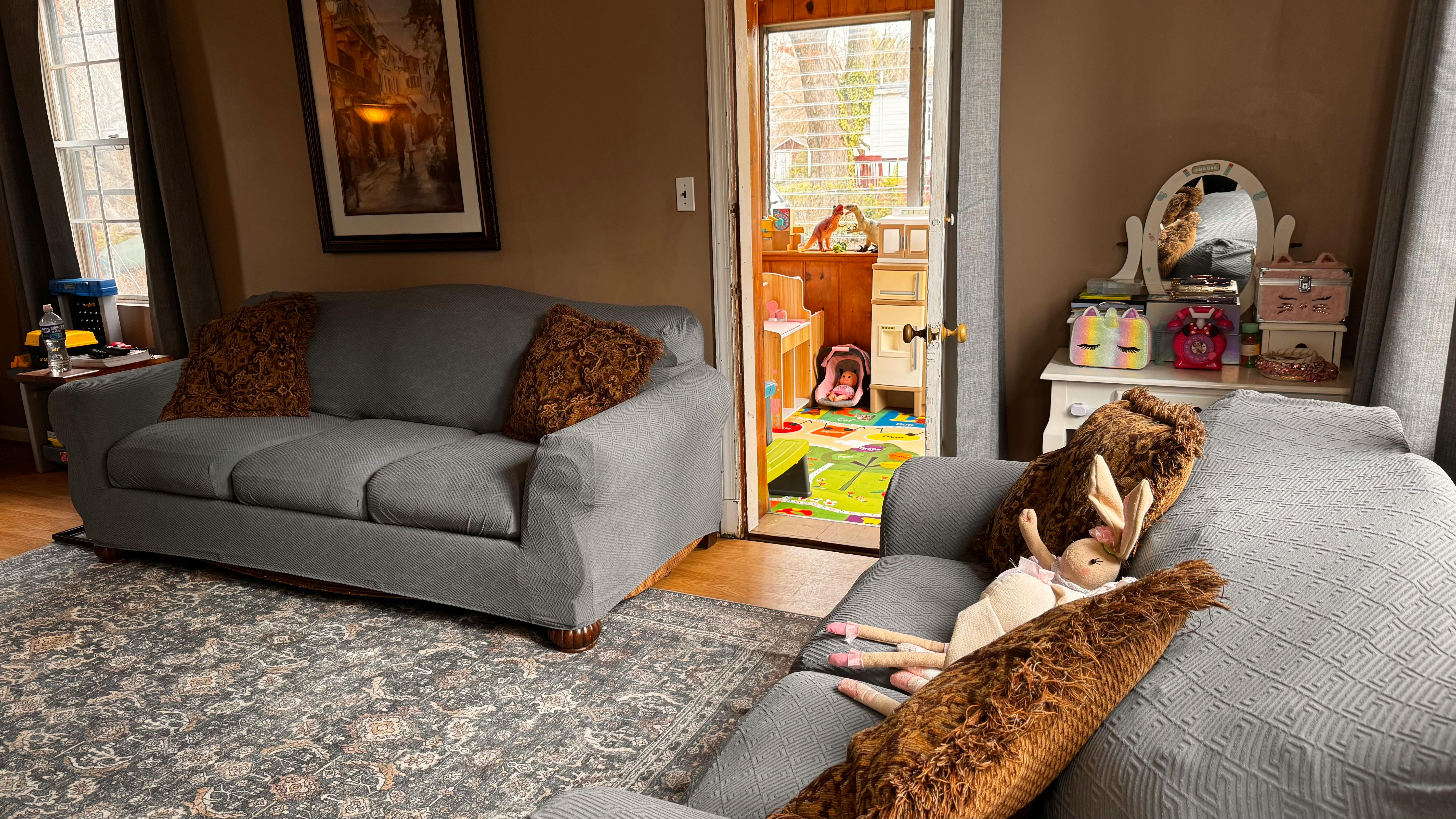 Child lying on a sofa with a blanket
