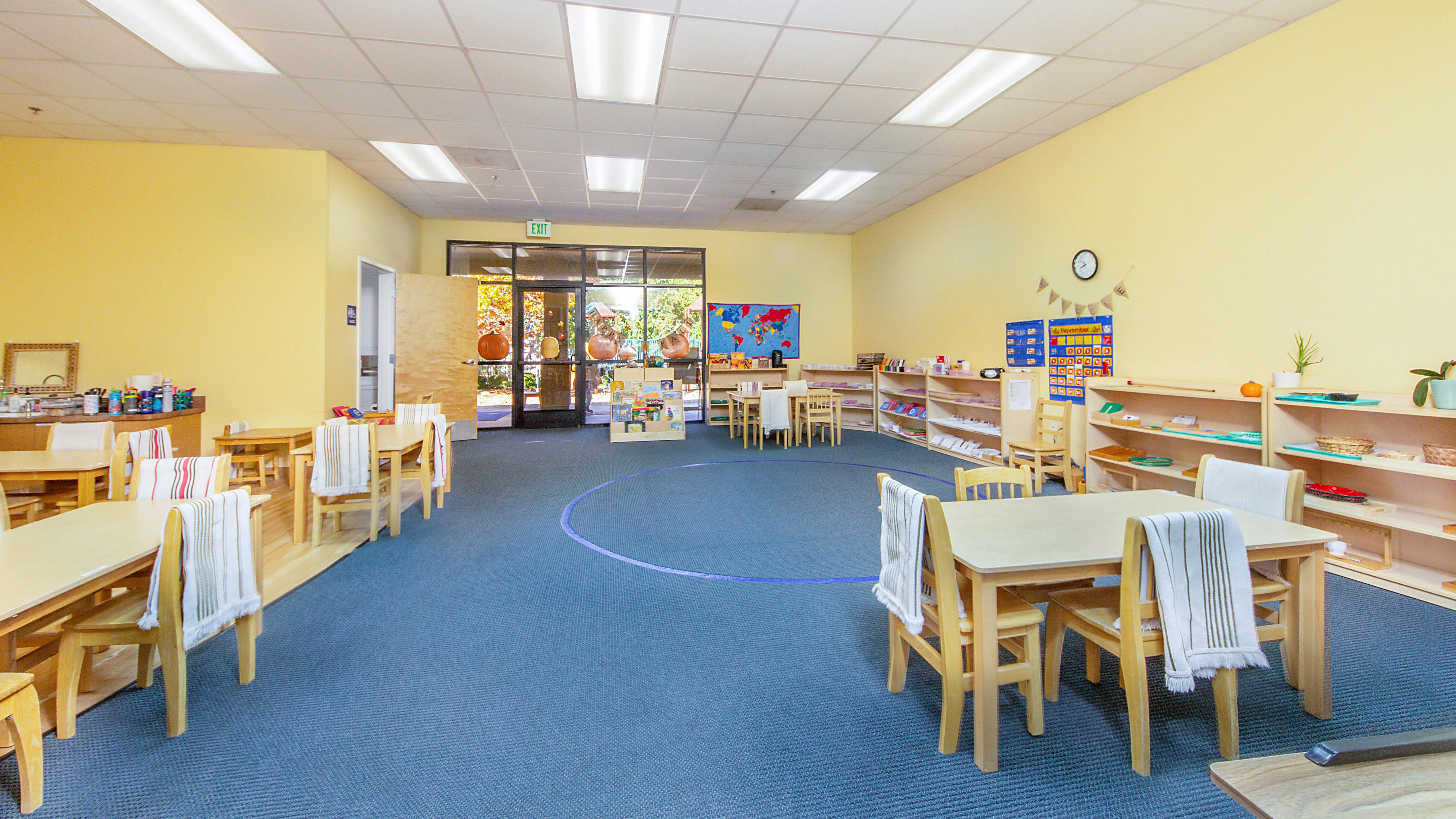 Empty classroom with small tables and chairs