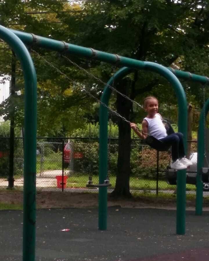Child on a swing at a playground