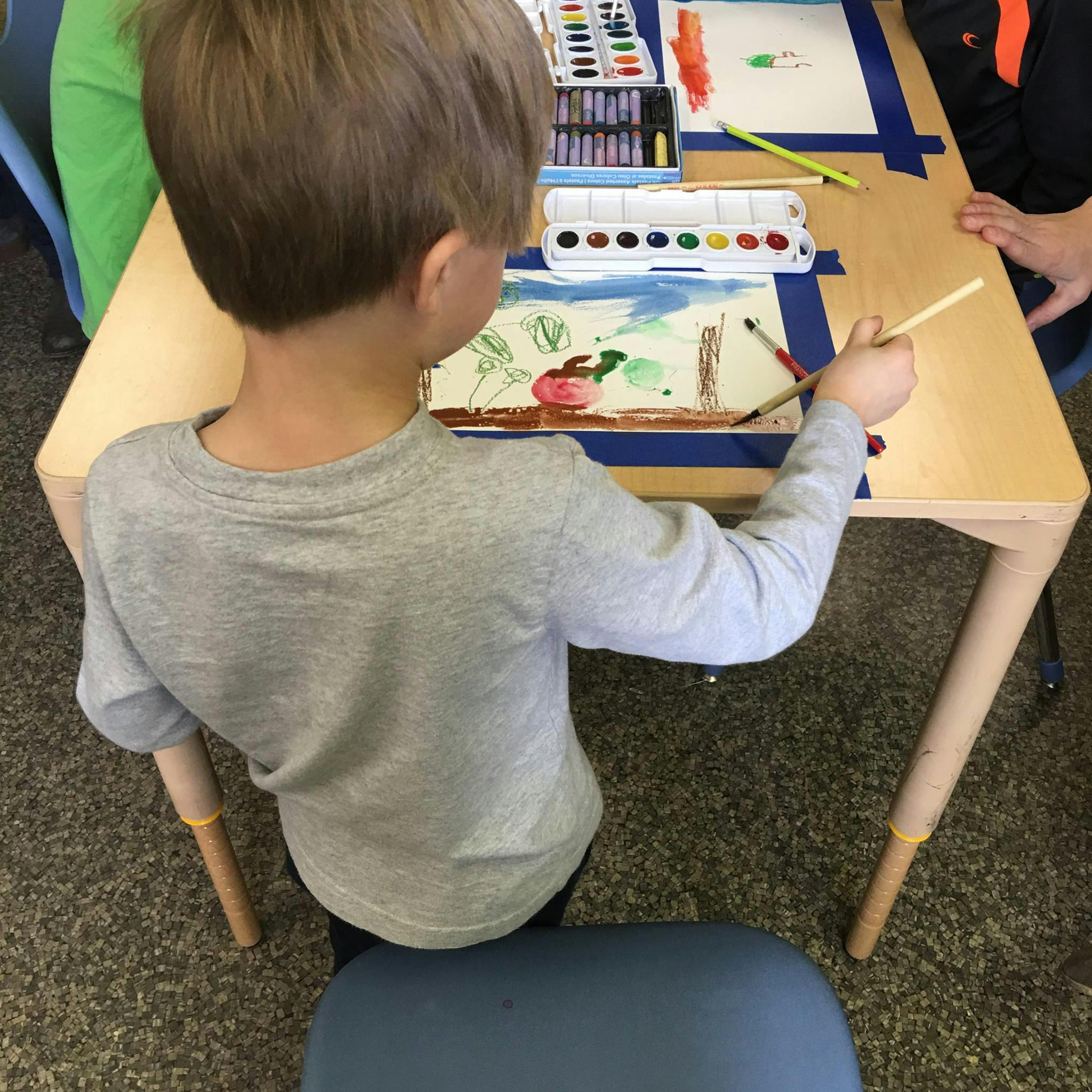 Child painting at a table