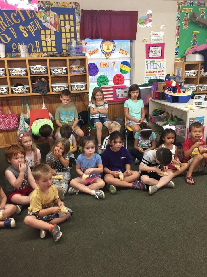 Children sitting on the floor in a classroom