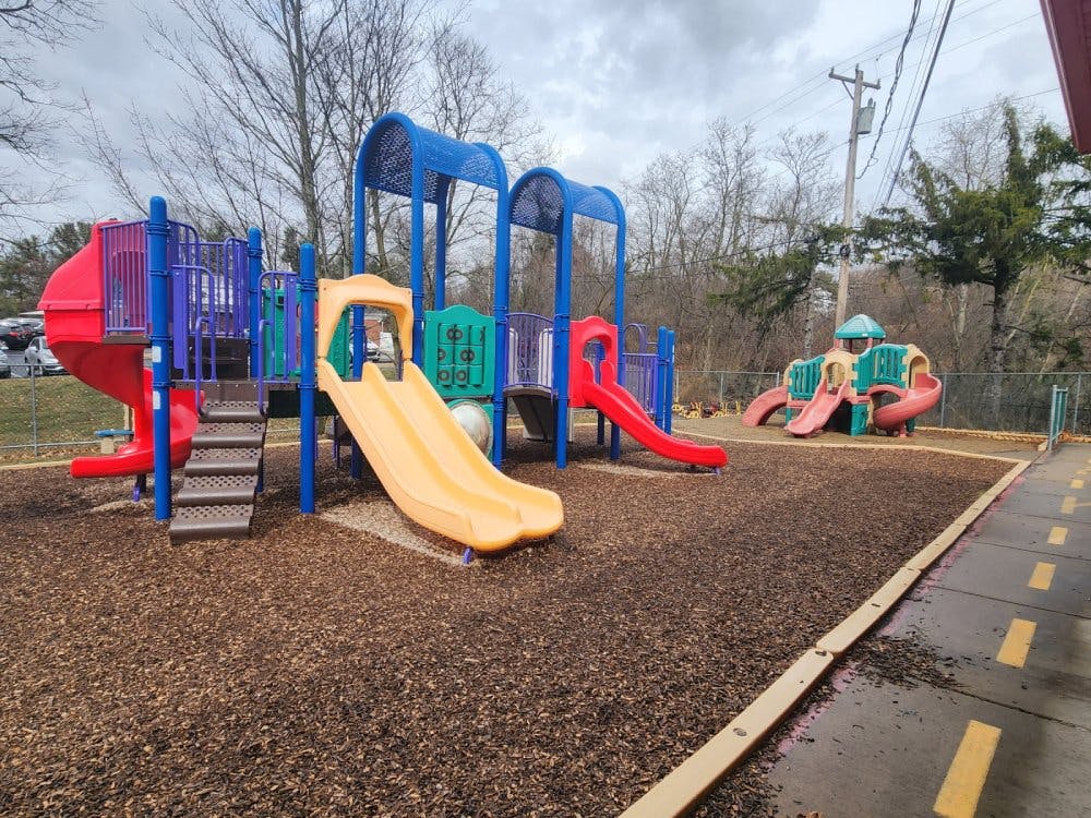 Colorful outdoor playground with multiple slides and climbing structures