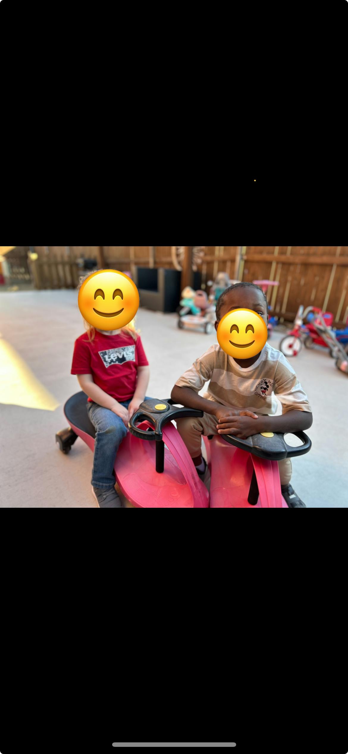 Two children sitting on ride-on toys