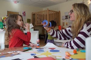 Adult and child doing crafts at a table