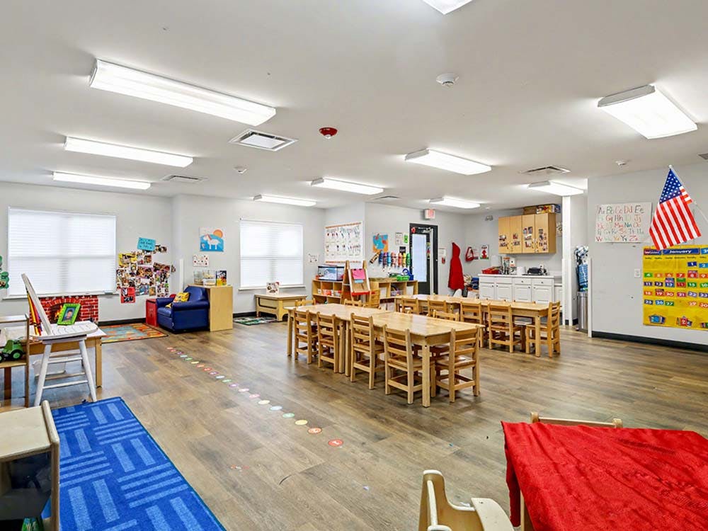 Empty classroom with small tables and chairs