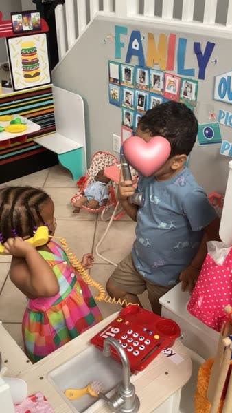 Two children playing with toy phones