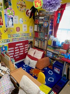 Colorful classroom with a reading nook and shelves of books