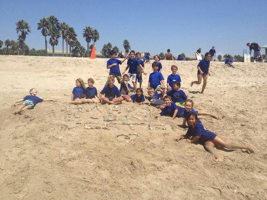 Group of children playing in sand on a beach