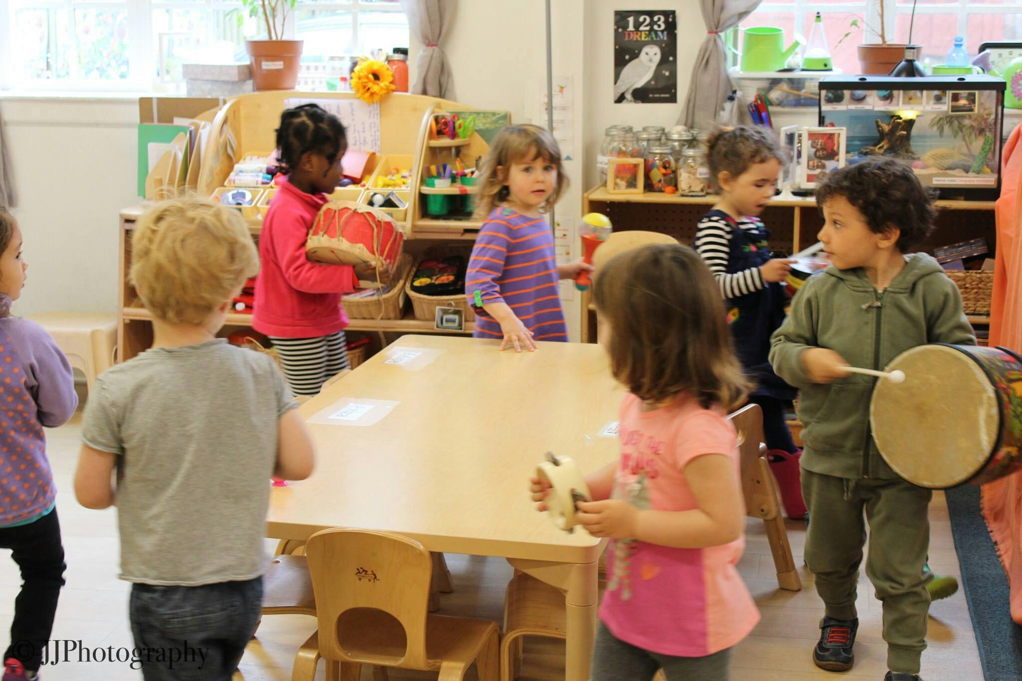 Children playing with musical instruments in a classroom