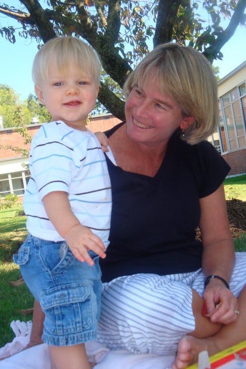 Adult and child sitting outdoors