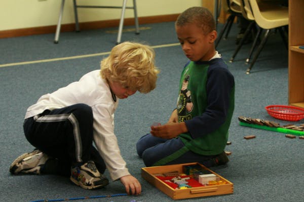 Two children playing with toys on the floor