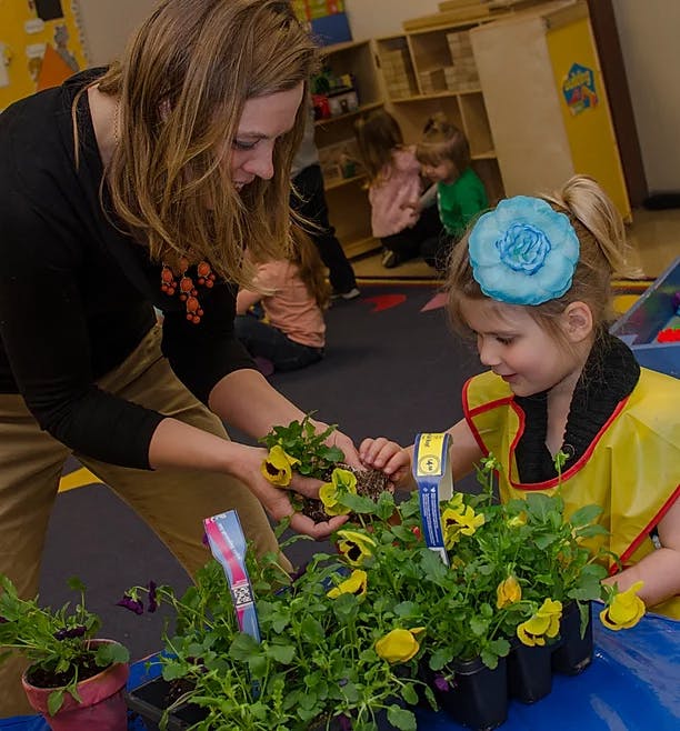 Person and child planting flowers