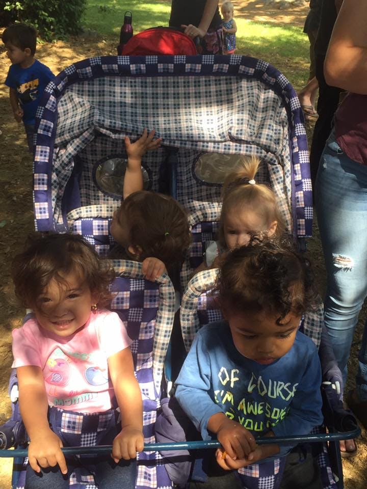 Multiple children in a plaid stroller