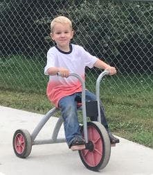 Child riding a tricycle