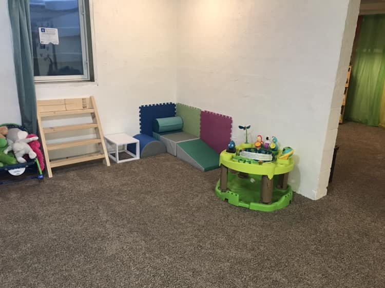 Playroom with soft play equipment and baby activity center