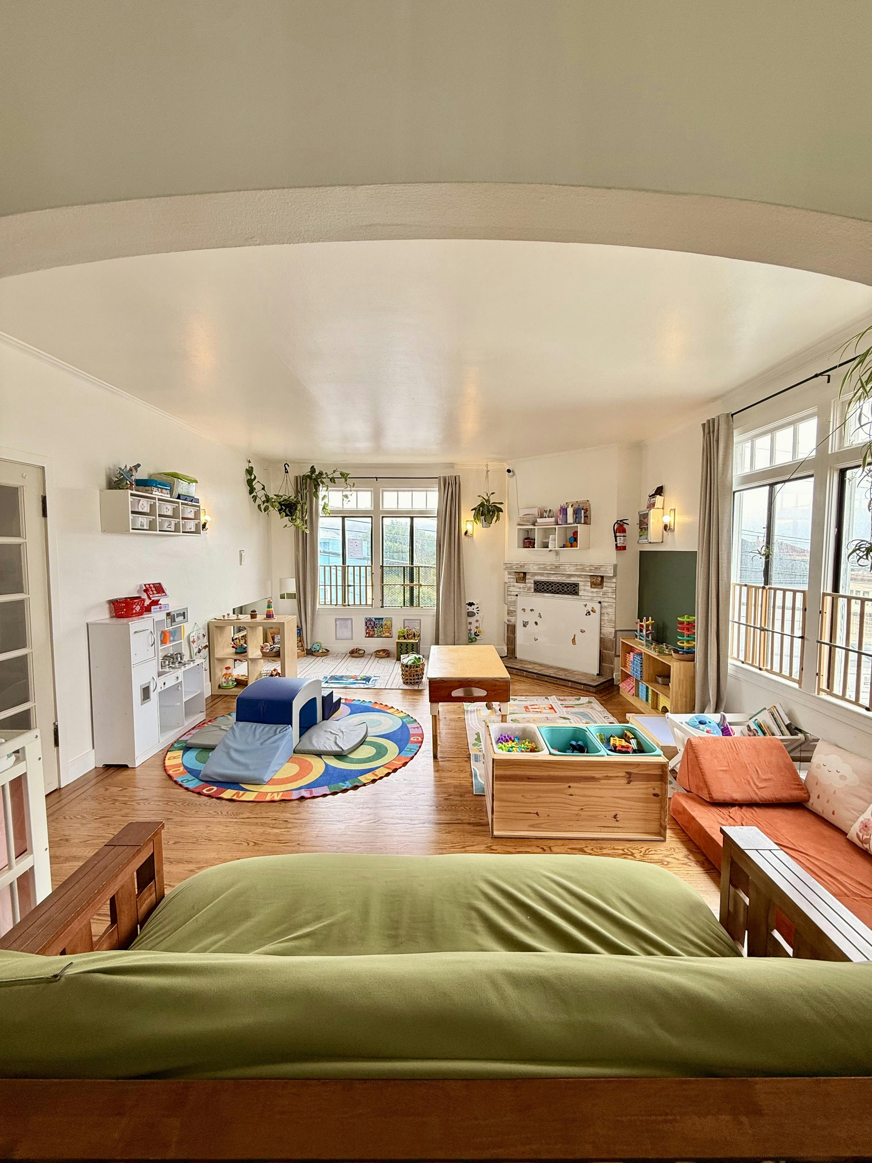 Playroom interior filled with children's toys, small furniture, and rugs