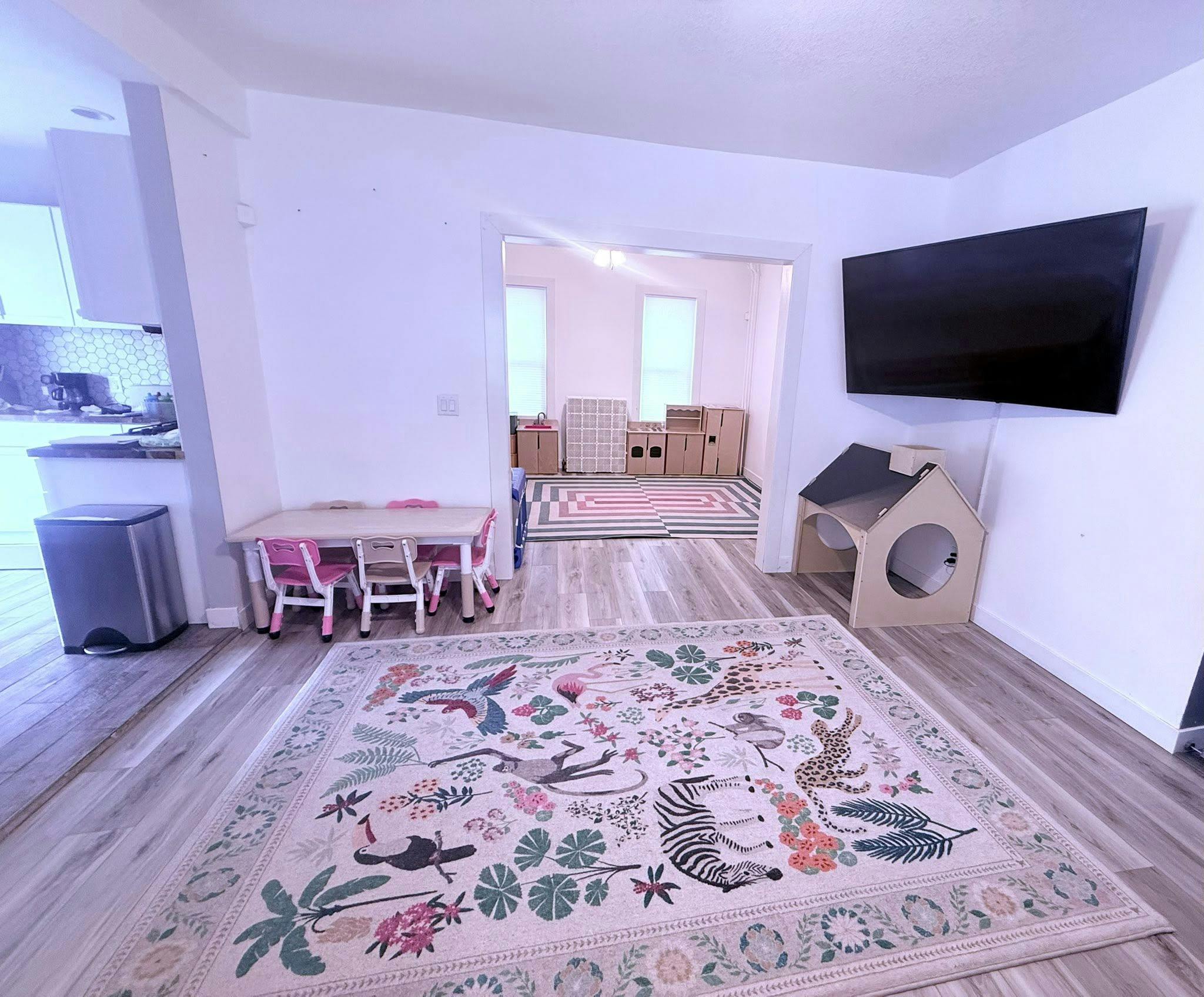 Playroom with children's table, chairs, and animal-patterned rug