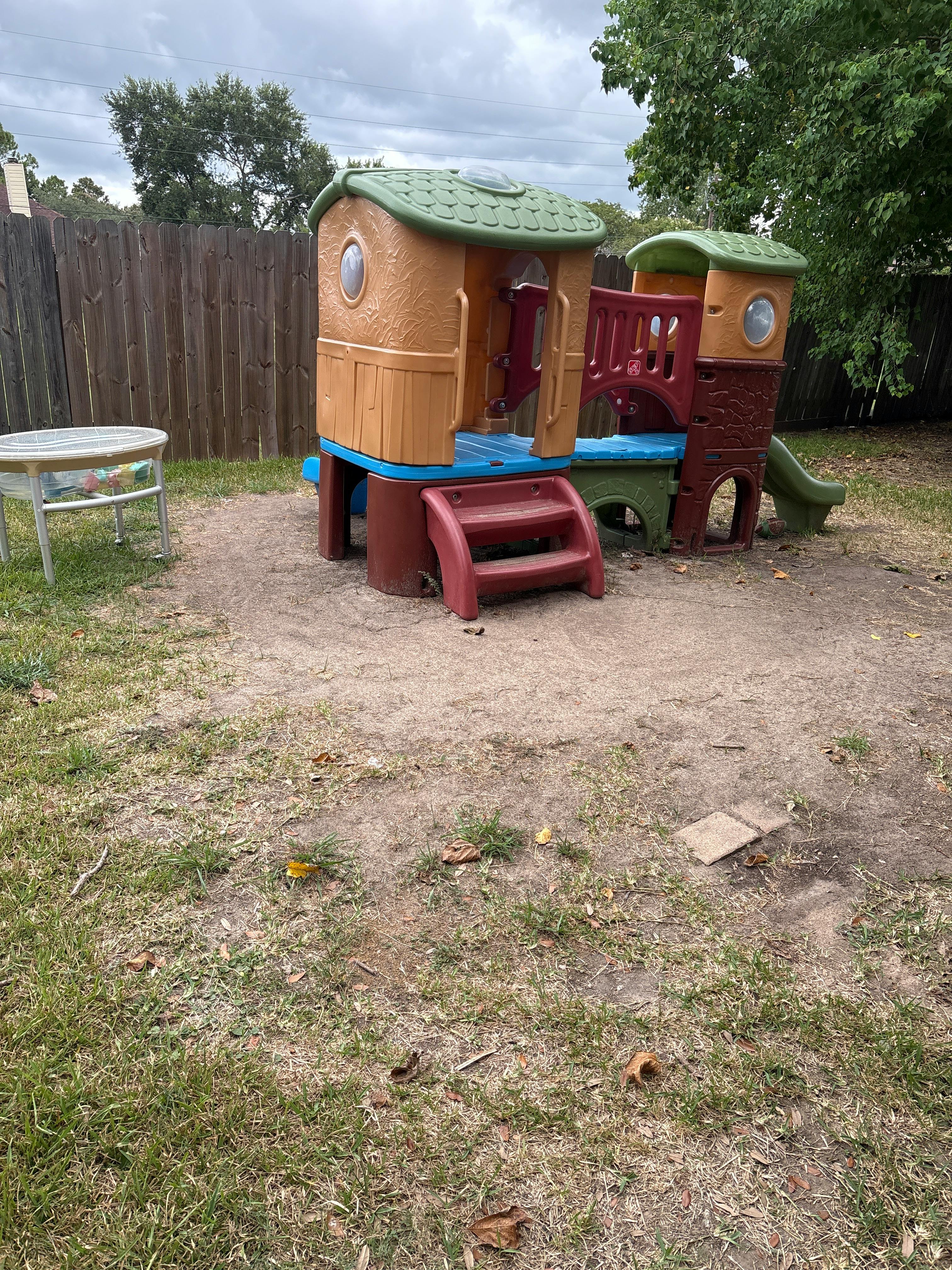 Plastic play structure in a backyard